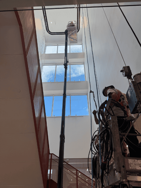 Crawler-mounted aerial work platform in interior staircase of office building photo 4 by SOSEQUIPMENT
