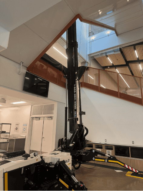 Crawler-mounted aerial work platform in interior staircase of office building photo 5 by SOSEQUIPMENT