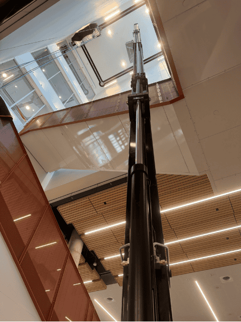 Crawler-mounted aerial work platform in interior staircase of office building photo 6 by SOSEQUIPMENT